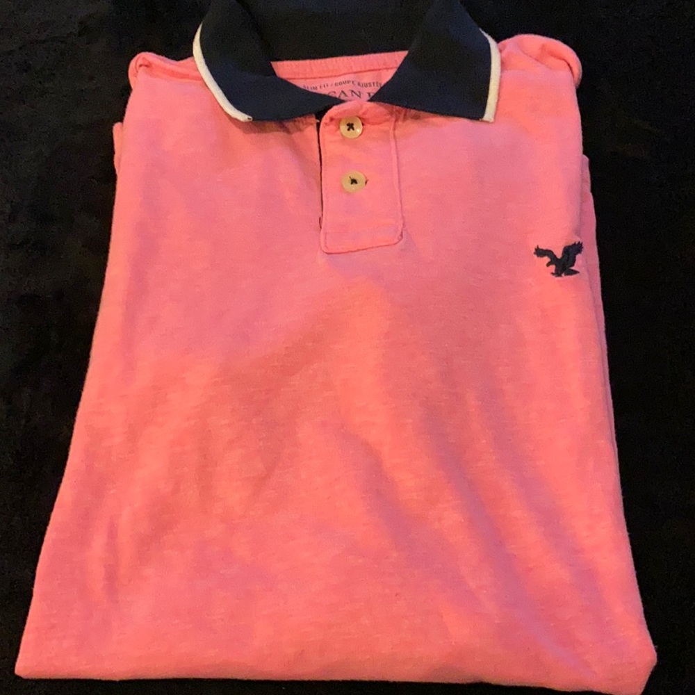 Bright pink polo shirt with a blue-collar American Eagle